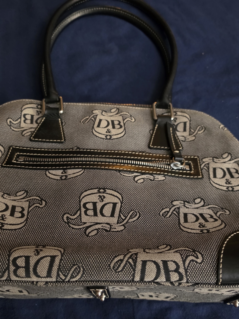 Dooney & Bourke satchel with signature DB logo print. Top zip pocket and leather